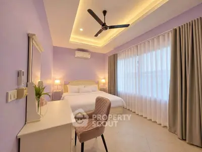 Elegant bedroom with modern ceiling fan and soft lighting, featuring a cozy bed and stylish decor.