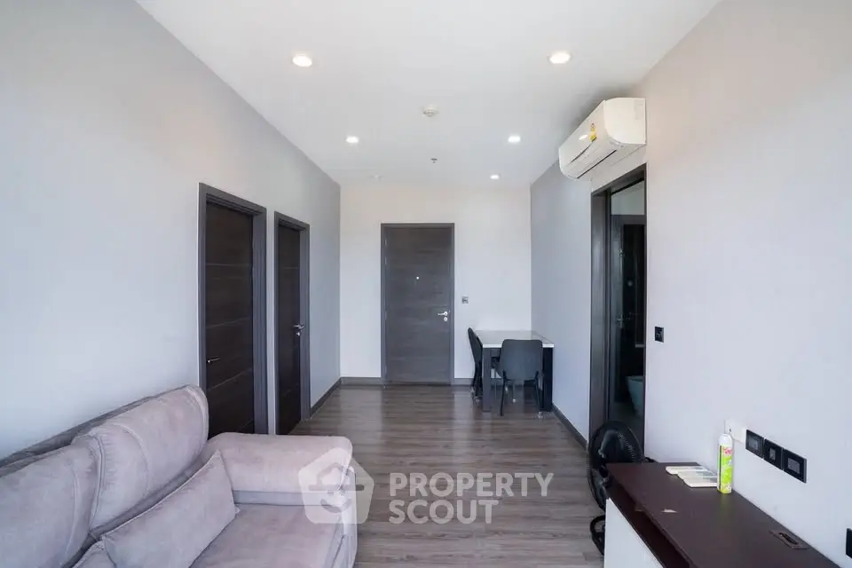 Modern living room with sleek design and air conditioning in a contemporary apartment.