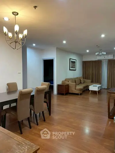 Spacious living room with elegant dining area and cozy seating, perfect for family gatherings.