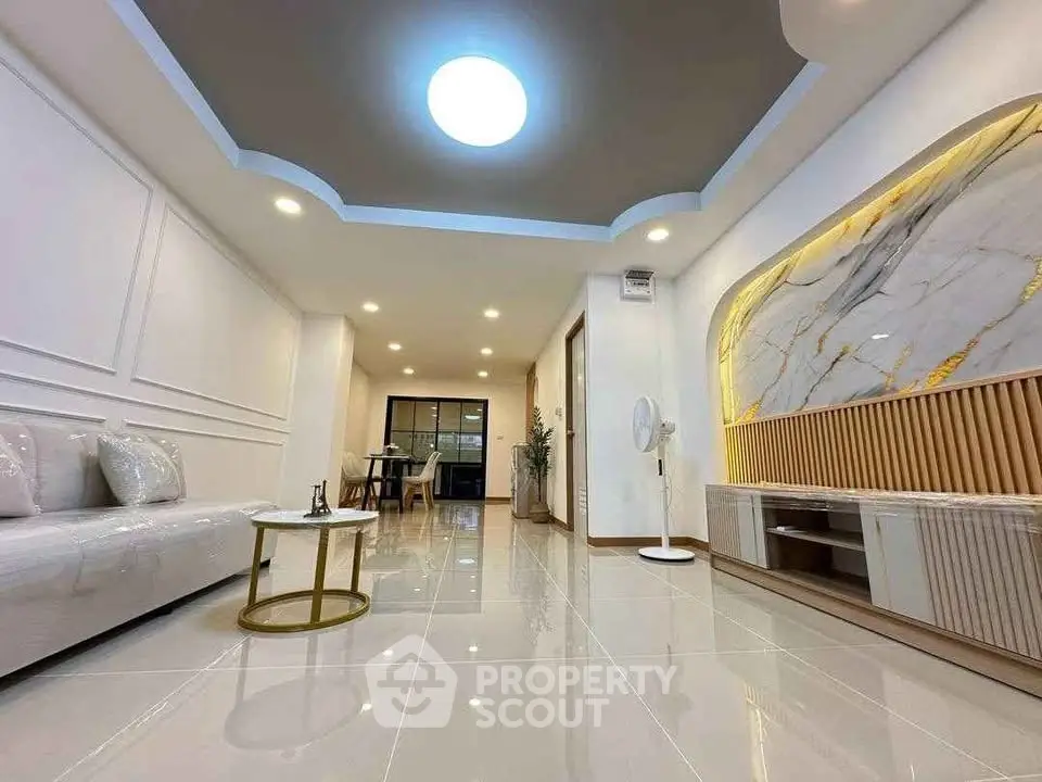 Luxurious modern living room with elegant ceiling design and marble accent wall