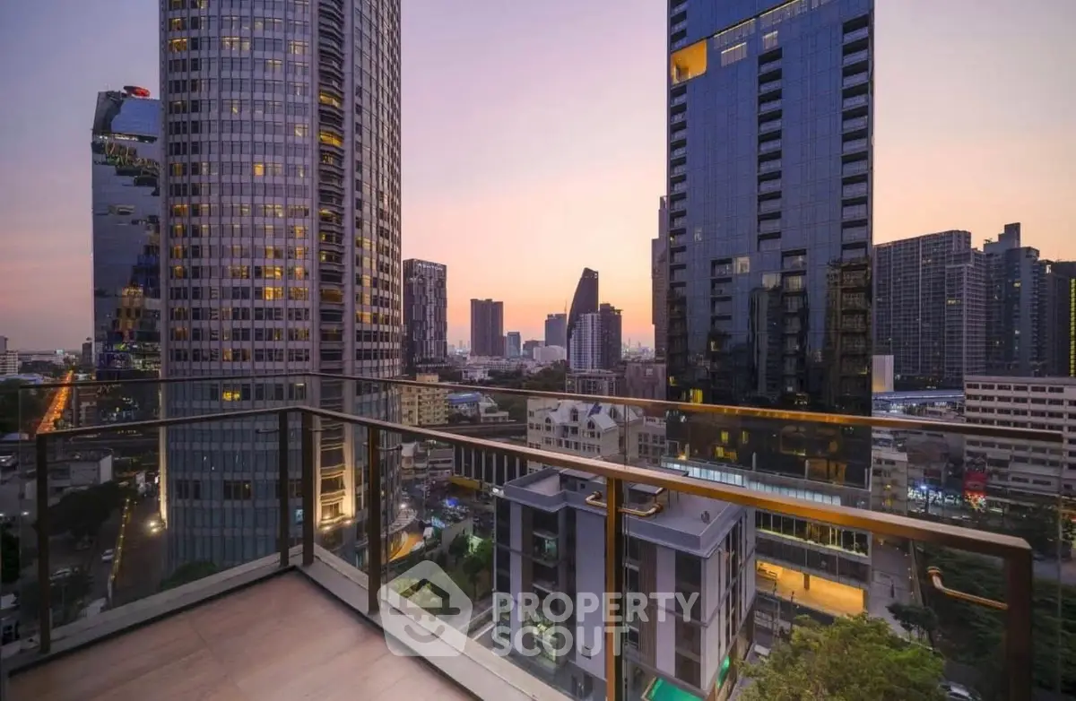 Stunning cityscape view from a modern high-rise balcony at sunset.