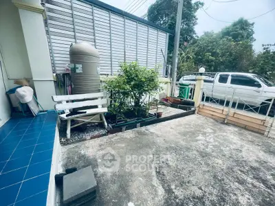 Charming outdoor patio with garden and seating area, perfect for relaxation and entertaining.