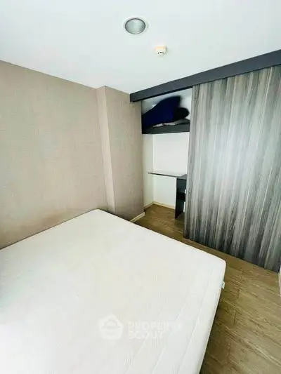 Modern bedroom with minimalist design and built-in closet, perfect for urban living.