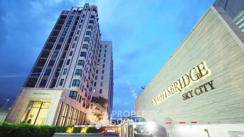 Luxurious high-rise building exterior of Knightsbridge Sky City with elegant entrance at dusk.