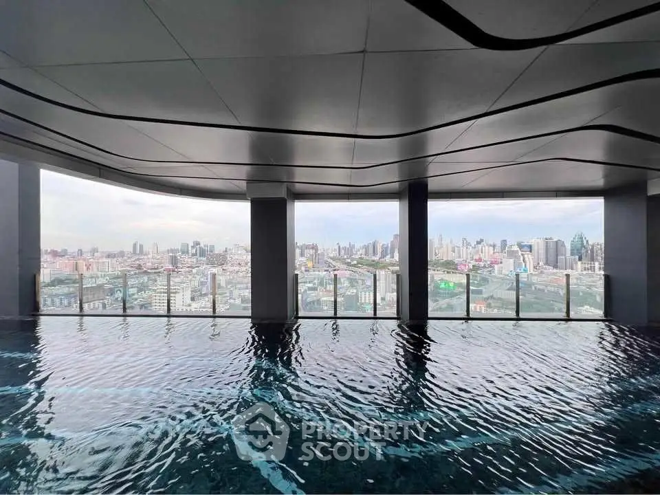 Stunning rooftop pool with panoramic city skyline view, perfect for luxury urban living.