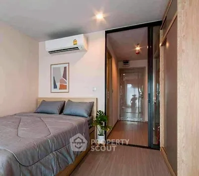 Modern bedroom with sleek design and air conditioning in a cozy apartment.