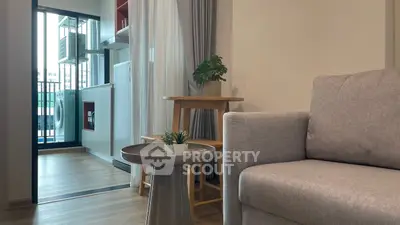Modern living room with balcony view and stylish furniture in urban apartment.