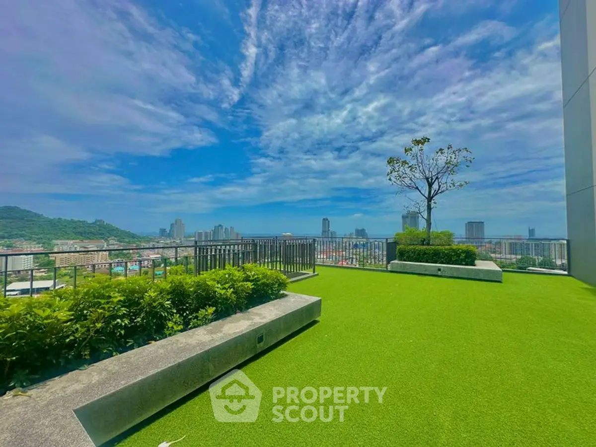 Stunning rooftop garden with panoramic city views and lush greenery.