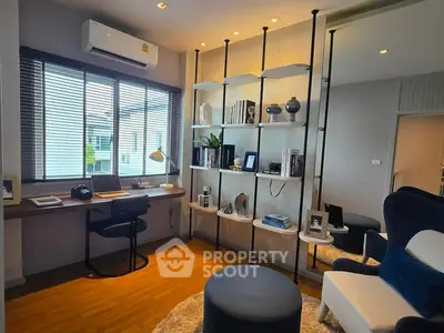 Modern study room with stylish shelving and large window offering natural light.