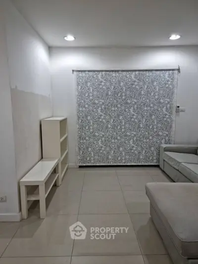 Spacious living room with elegant patterned curtain and modern furniture