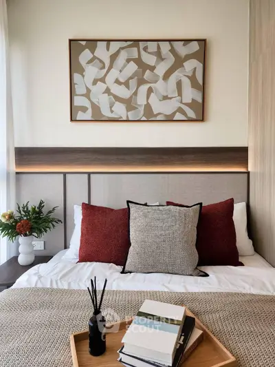 Stylish bedroom with modern decor and cozy bedding in a contemporary apartment.