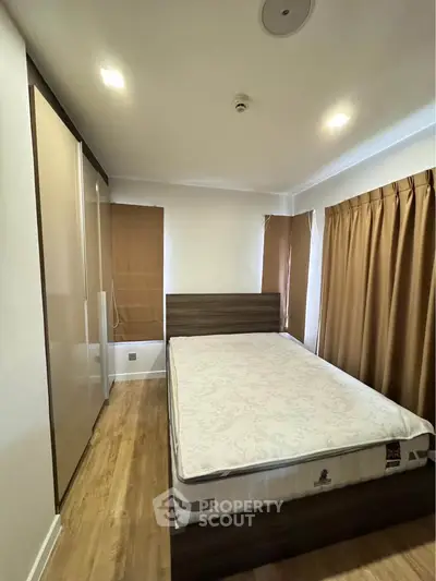 Cozy bedroom with wooden flooring and modern furnishings