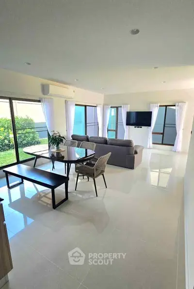 Spacious modern living room with garden view and elegant furnishings