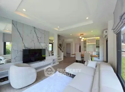 Luxurious modern living room with elegant marble accents and spacious seating area.