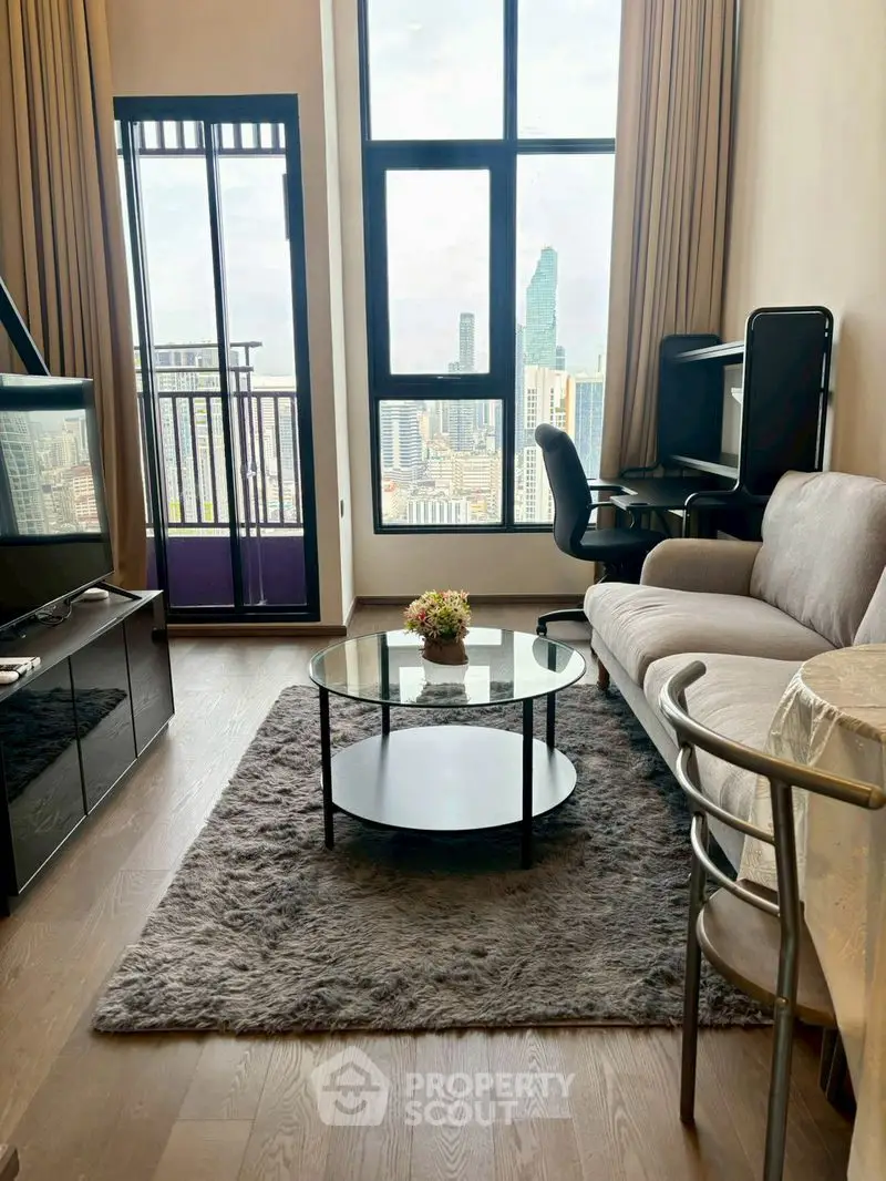 Modern living room with city view, featuring stylish furniture and floor-to-ceiling windows.