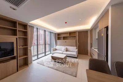 Modern living room with sleek furniture and large windows in a stylish apartment.