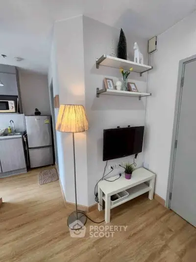 Cozy living room with modern decor and open kitchen layout in a stylish apartment.