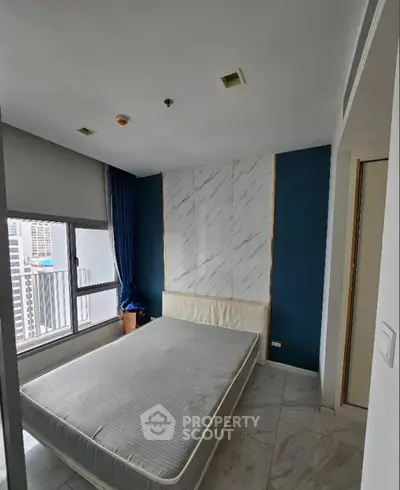 Modern bedroom with city view and stylish marble accent wall