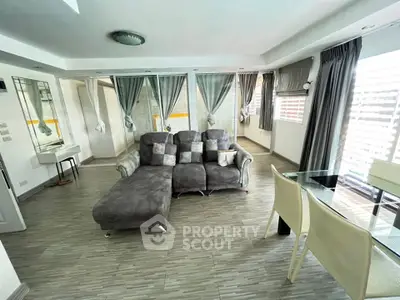 Spacious modern living room with stylish decor and ample natural light