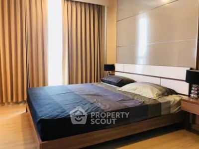 Modern bedroom with stylish decor and ample natural light