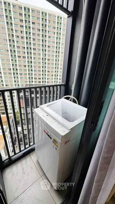 Compact balcony with washing machine in modern high-rise apartment