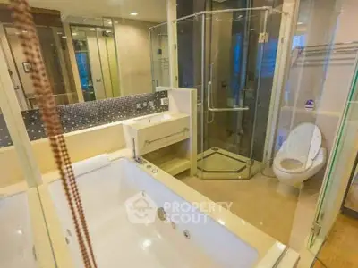 Luxurious bathroom with jacuzzi tub and glass shower enclosure