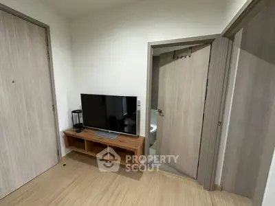 Modern interior with sleek TV setup and wooden accents