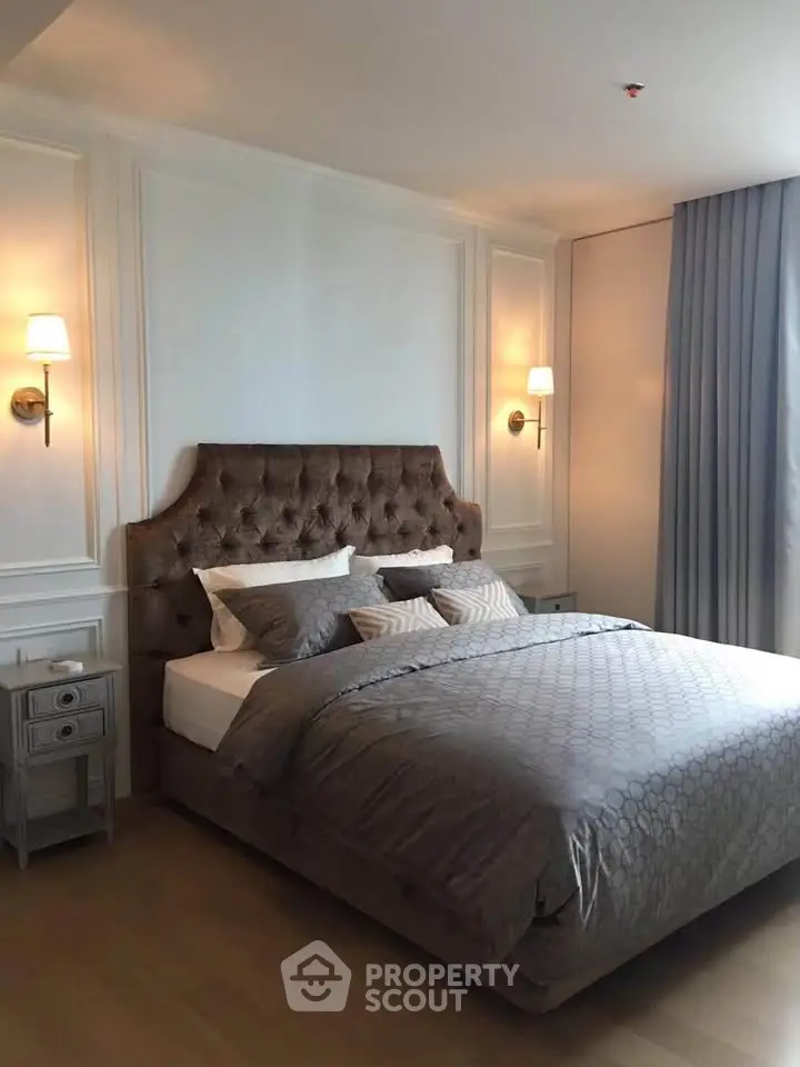 Luxurious bedroom with elegant decor and plush bedding in a modern apartment.