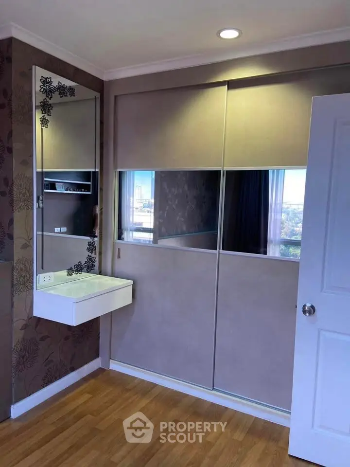 Modern bedroom with built-in wardrobe and stylish vanity mirror