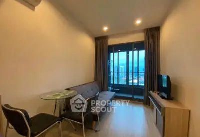 Cozy living room with city view and modern furnishings in a high-rise apartment.