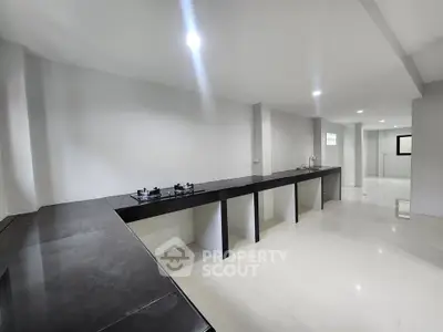 Spacious modern kitchen with sleek countertops and gas stove