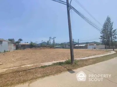 Expansive vacant land ready for development, boasting clear skies and potential for custom real estate projects, located in a serene neighborhood.