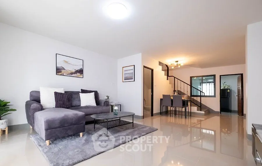 Spacious modern living room with stylish decor and open dining area