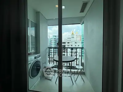 Modern balcony with city view, featuring a washing machine and cozy seating area.
