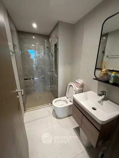 Modern bathroom with sleek fixtures and glass shower enclosure