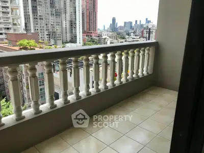 Spacious balcony with city skyline view, perfect for relaxation and enjoying urban living.