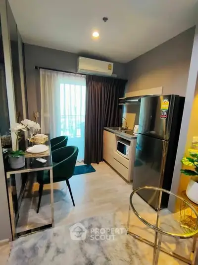 Modern compact kitchen with sleek appliances and stylish decor in a cozy apartment setting.