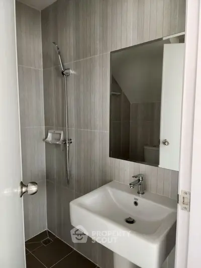 Modern bathroom with sleek sink and shower in minimalist design