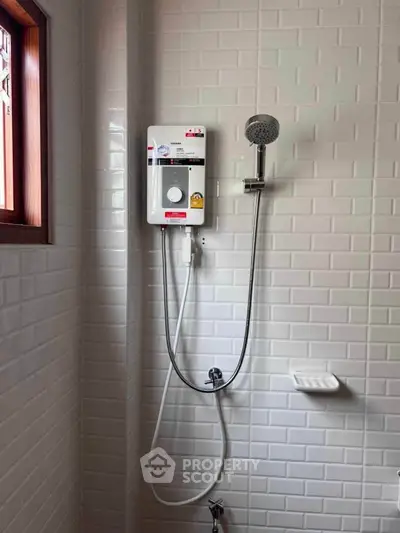 Modern bathroom with sleek shower and white subway tiles