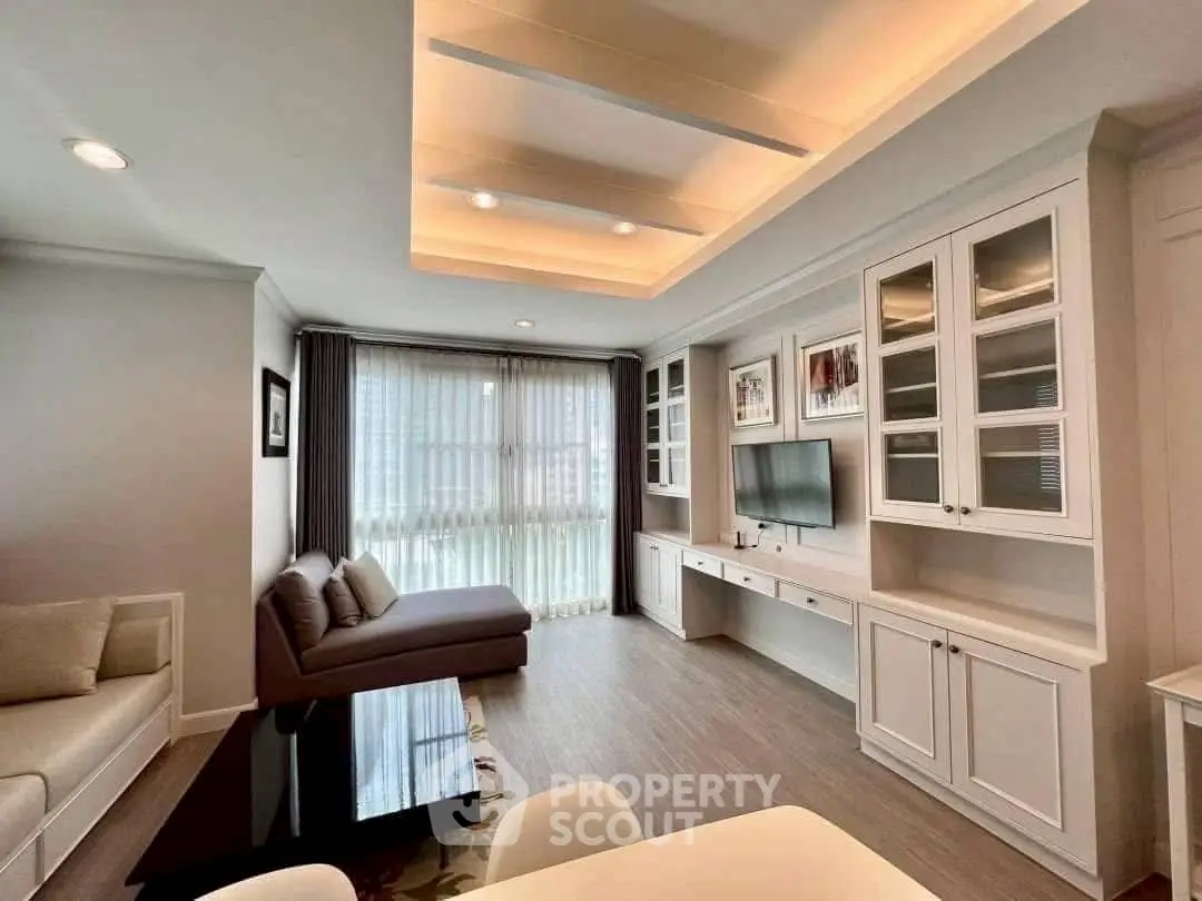 Spacious modern living room with elegant built-in cabinetry and large windows for natural light.
