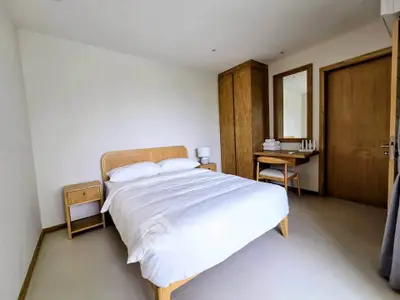 Cozy minimalist bedroom with wooden furniture and neutral tones