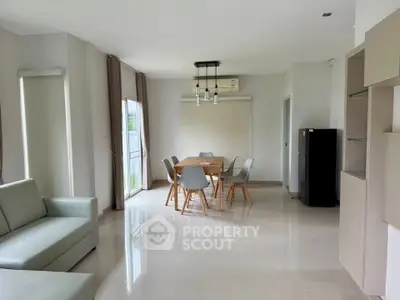 Spacious modern living room with dining area and sleek furniture