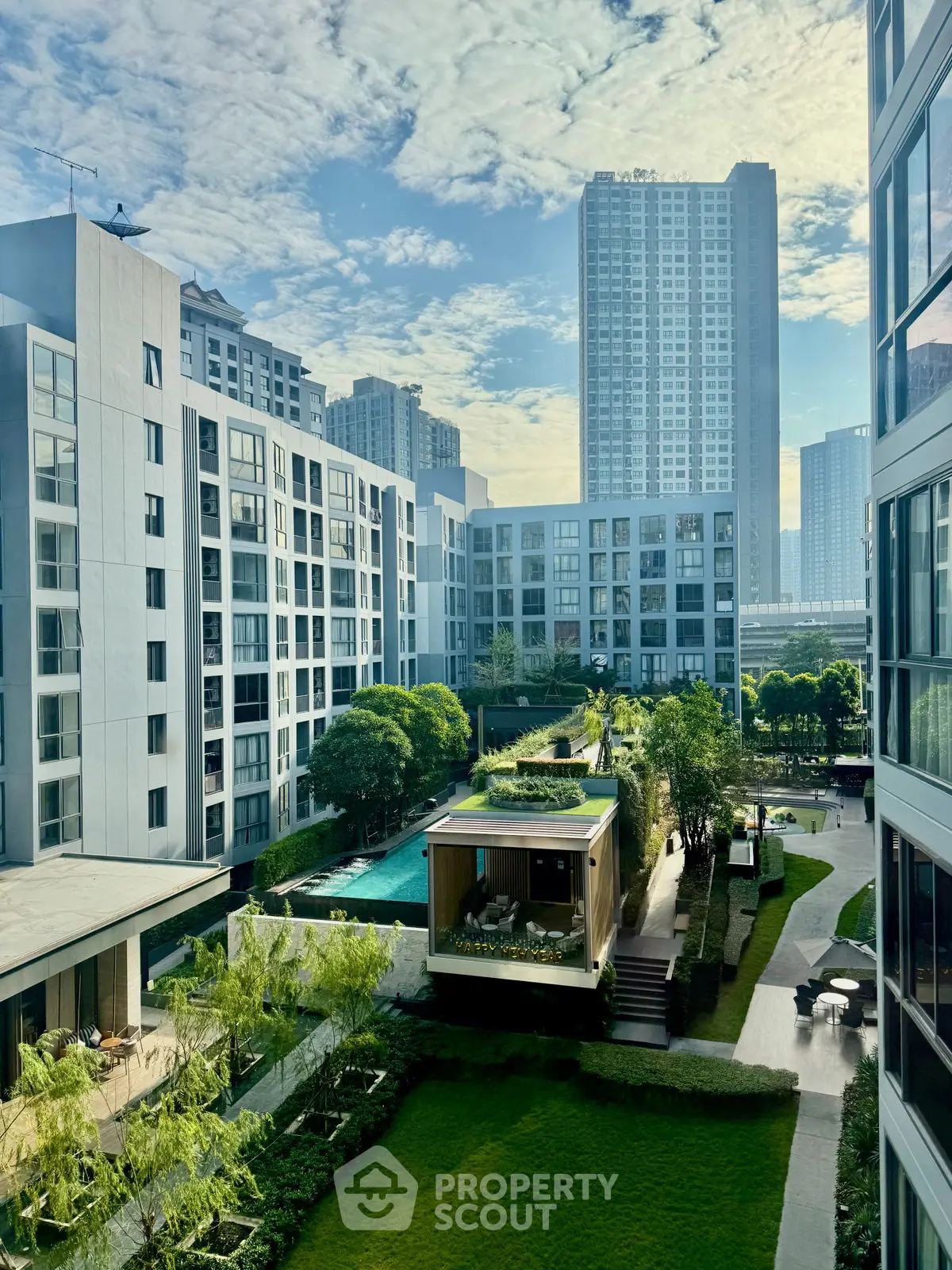 Stunning urban apartment complex with lush garden and pool view