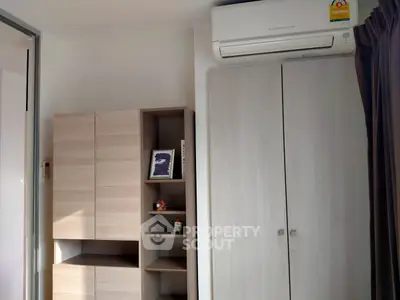 Modern bedroom with sleek storage and air conditioning unit