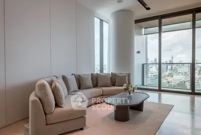 Luxurious living room with panoramic city view and modern decor.