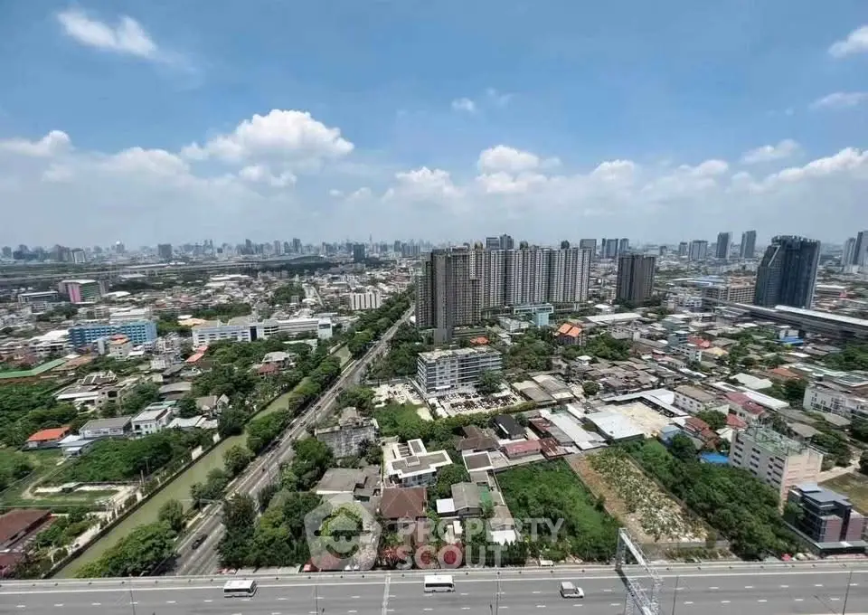 Stunning aerial view of urban skyline with high-rise buildings and lush greenery, perfect for real estate investment.