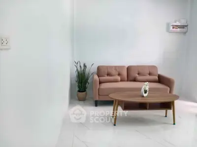 Modern living room with stylish sofa and coffee table, perfect for cozy gatherings.