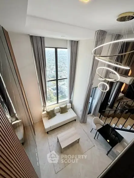 Luxurious high-ceiling living room with stunning city view and modern decor