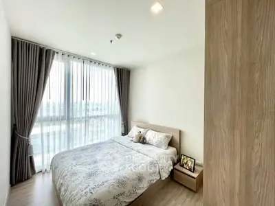 Bright and cozy bedroom with large window and modern decor