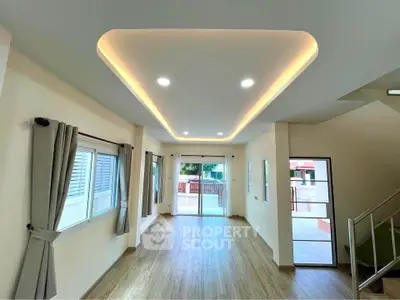 Spacious modern living room with stylish ceiling lights and large windows